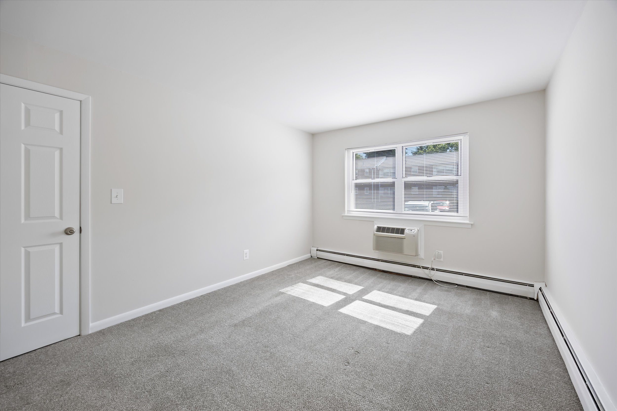 A room with a window and a door.